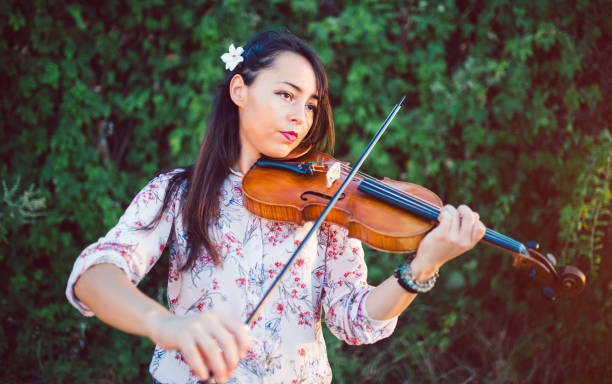 istock Girl violinist in nature 1013683700