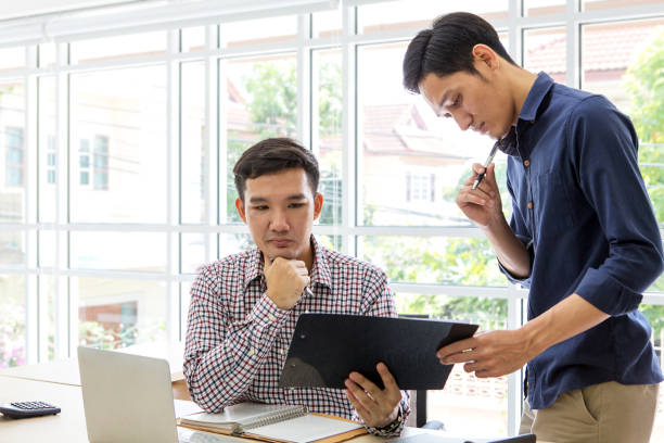 istock Business people working and discussing in the office. Two Male Using Computer and internet. Businessman plaining data at room. business working together on project. asian people. 1013683898