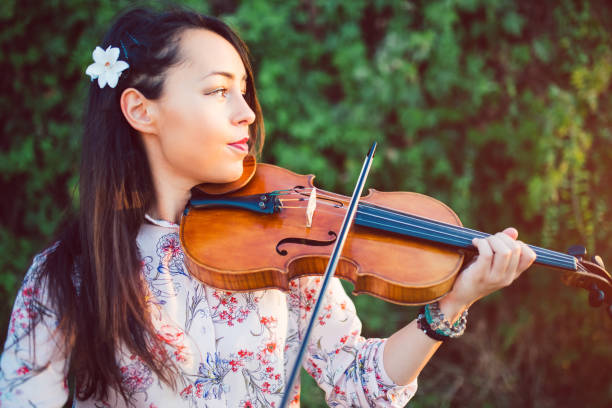 istock Girl violinist in nature 1013684092