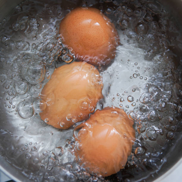 끓는 물에 난로에 계란 - 끓는 물에 삶기 뉴스 사진 이미지