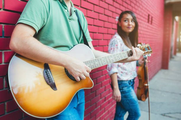istock Musicians with guitar and violin 1013697682