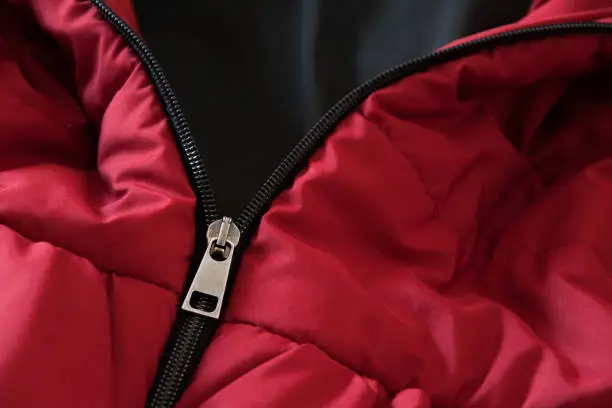 Photo of Close up of red down jacket, winter fashion outfit