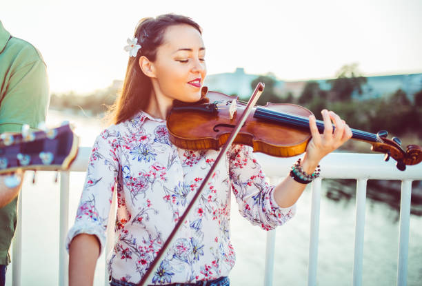 istock Girl violinist on the bridge 1013708164