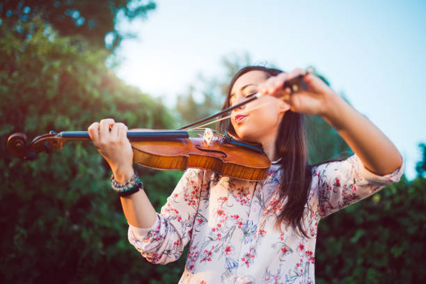istock Girl violinist in nature 1013710450