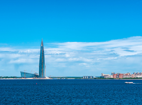 Under the final stages of construction, the Lakhta Center in the harbour on the outskirts of St Petersburg, Russia. The complex is intended for public facilities, retail and office use. At 463 metres high it is thought to be the tallest building in Europe and the second-highest building in the world. On the right, one of the frequent hydrofoils makes its way across the harbour.