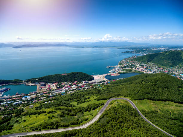 istock Aerial panorama above town, mountains, road and bay 1013718708