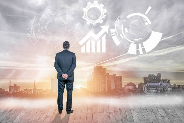 istock Businessman looking at interface against cityscape in background 1013719070