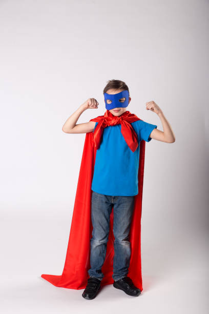 istock Playful superman kid posing and shows his muscle 1013719450