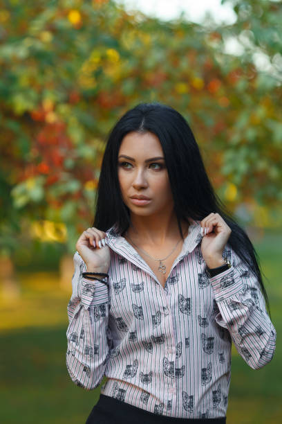istock Beautiful young brunette in the park 1013725196