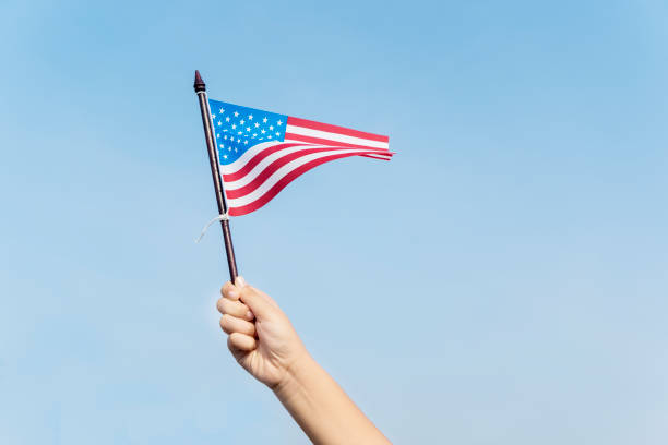 istock Unknown child waving an American flag 1013734242