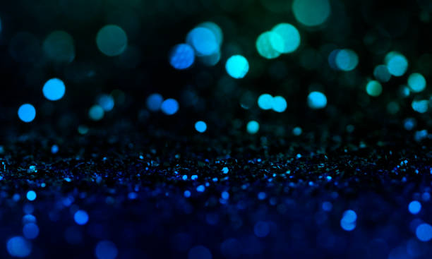 istock Christmas light background.  Holiday glowing backdrop. Defocused Background With Blinking Stars. Blurred Bokeh. 1013734970