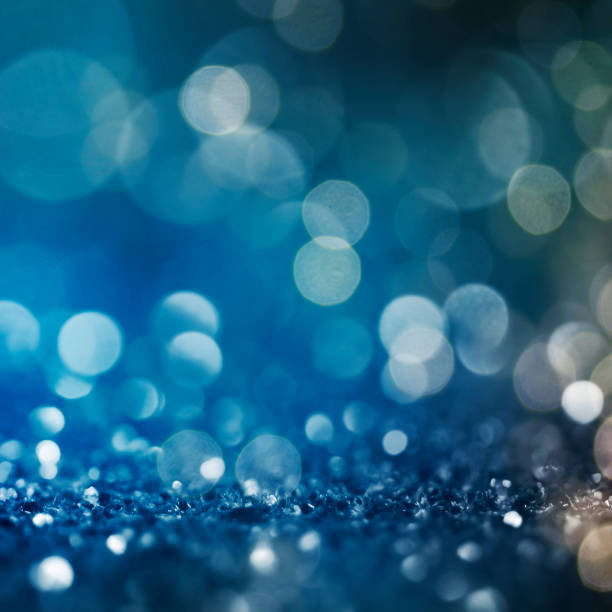 istock Christmas light background.  Holiday glowing backdrop. Defocused Background With Blinking Stars. Blurred Bokeh. 1013735050