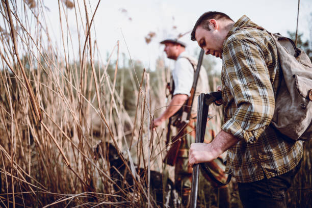 istock Male Hunter Checking His Rifle While Walking On Hunting Trip 1013739616