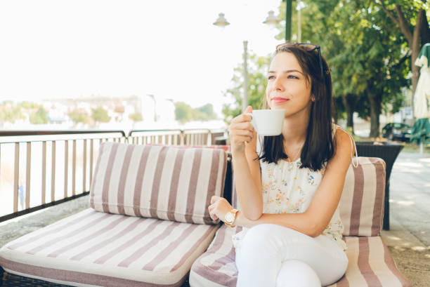 istock Woman sitting at cafe and drink coffee 1013739794