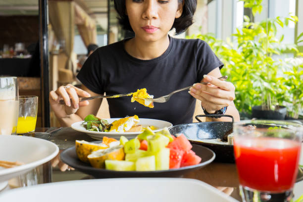 istock Young woman eating steak in the restaurant 1013740154