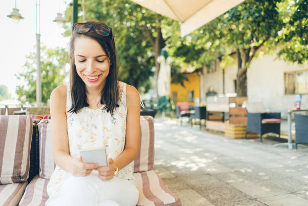 istock Girl using her smartphone outdoor 1013743014