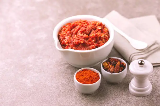 Photo of Traditional Maghrebi hot chili pepper sauce paste harissa. adjika