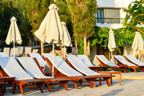 istock Row of empty sunbeds on the hotel terrace at sunset 1013744402