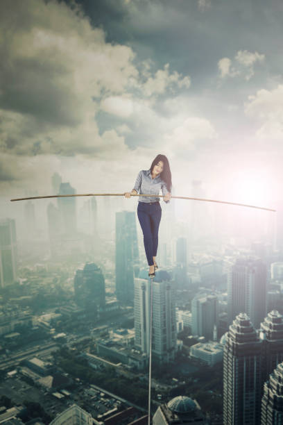 istock Young businesswoman standing on a rope 1013751500