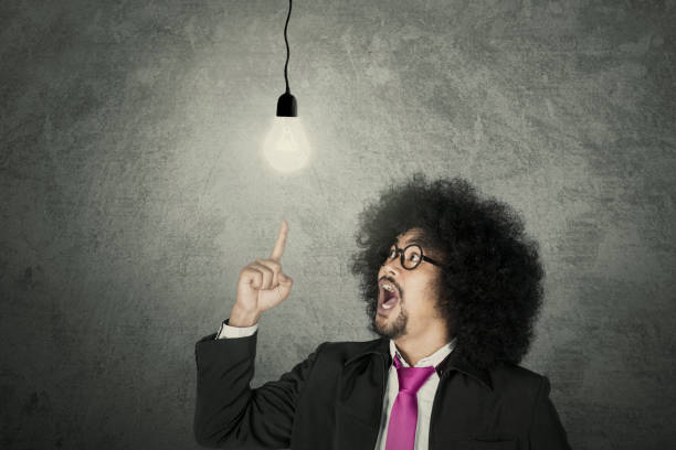 istock Businessman with glowing light bulb 1013751718