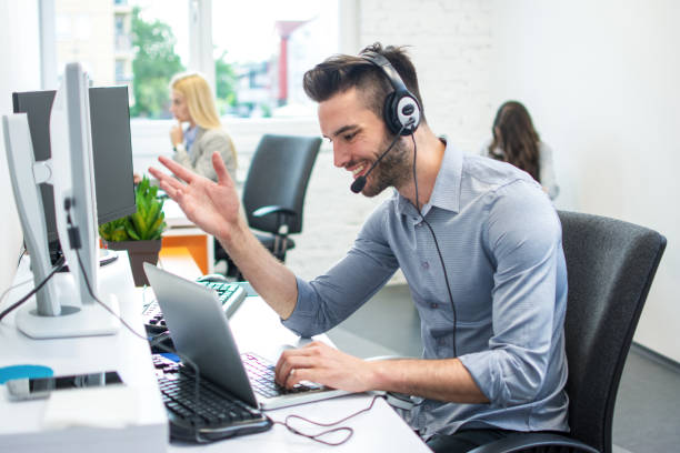 istock Portrait of handsome customer service executive with headset using laptop in office 1013752014