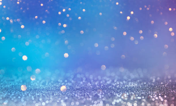 istock Christmas light background.  Holiday glowing backdrop. Defocused Background With Blinking Stars. Blurred Bokeh. 1013756594
