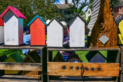 Sharon, Connecticut USA August 1, 2018 A couple studying birdhouses at a farmer's market on the town green.