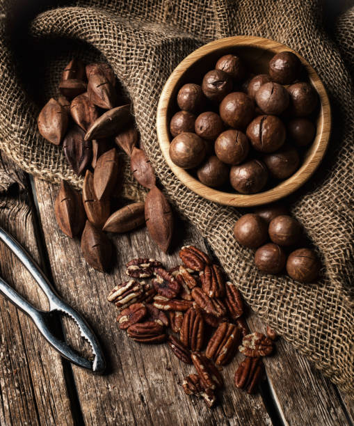 istock Macadamia, Pecan and Pili nuts on wooden table 1013764762