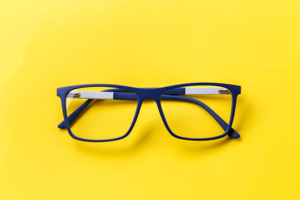 istock glasses with transparent lenses with diopters on a yellow background. 1013764928
