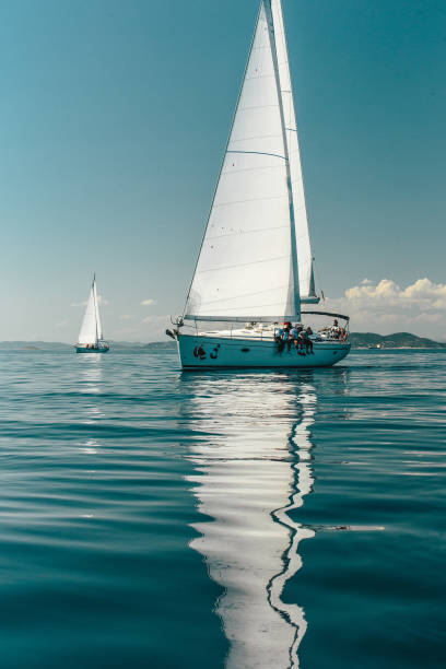 istock Two yachts sailing in a blue sea 1013765268