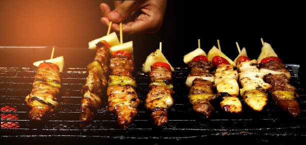 The chef is grilling the barbecue on the stove.