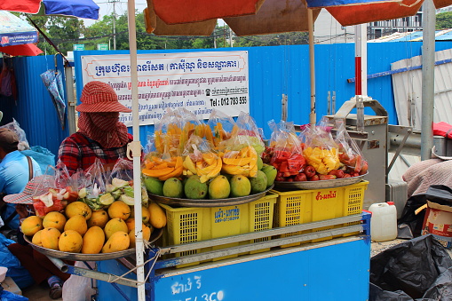 Poipet, Cambodia - Mart 27, 2018: street vendor of exotic fruits on the border of Cambodia and Thailand