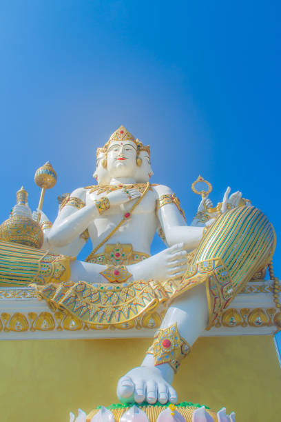 istock Giant white Brahma statue with blue sky background. Brahma is the Hindu Creator god. He is also known as the Grandfather and supreme in the triad of great Hindu gods which includes Shiva and Vishnu. 1013792490