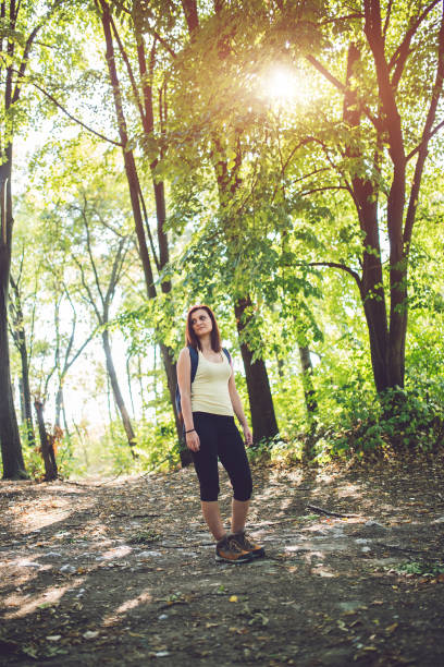 istock Caucasian woman with backpack in forest. 1013792880