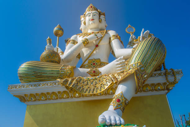 istock Giant white Brahma statue with blue sky background. Brahma is the Hindu Creator god. He is also known as the Grandfather and supreme in the triad of great Hindu gods which includes Shiva and Vishnu. 1013795130