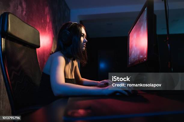 A Cute Female Gamer Girl Sits In A Cozy Room Behind A Computer And Plays Games Woman Live Streaming Computer Video Games To Her Fans Streamer And Gamer Concept Stock Photo - Download Image Now