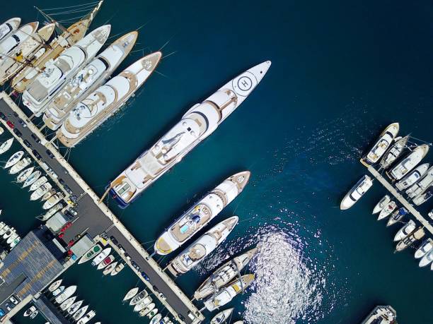 Aerial view of super yachts in harbor on the Mediterranean coast Yachts line the Harbour in Monaco - Monte Carlo mast sailing photos stock pictures, royalty-free photos & images