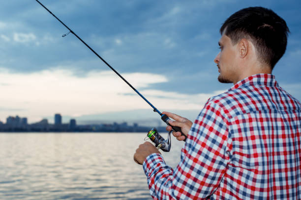 istock Fishing in the river at sunset. 1013803120