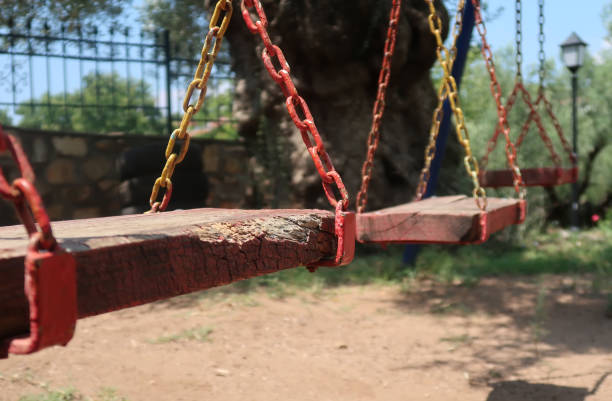 istock Wooden swing hanging 1013803636