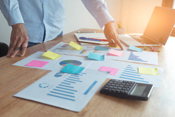 istock Heavy work for architects Or engineers are working on projects at their own desks with graphics, laptops, phones and notebooks. 1013807050