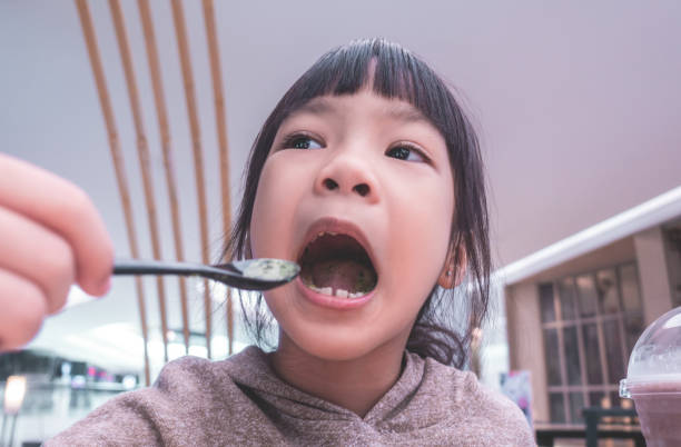istock Little kid is happy eating green tea matcha cake roll 1013809594