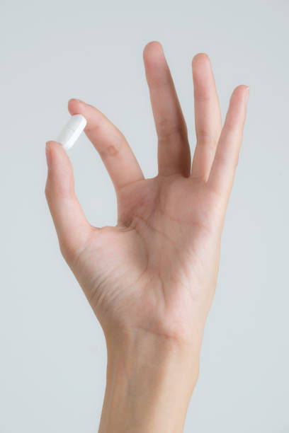 istock Closeup woman hand showing pills. 1013813842