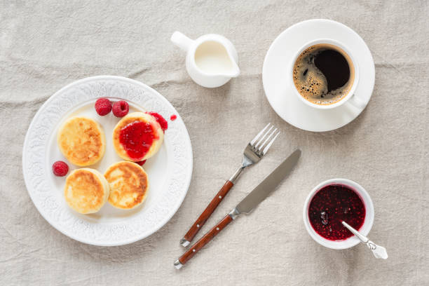 istock Cottage cheese pancakes with raspberry jam and coffee 1013814172