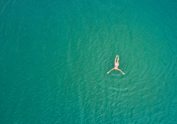 istock girl swims from the sea 1013821364