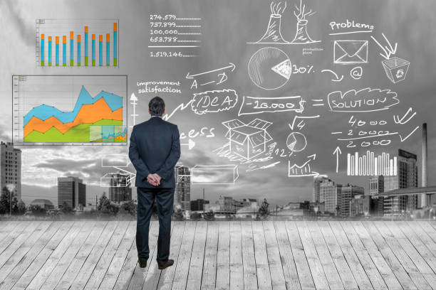 istock Businessman looking at business plan against city background 1013823242