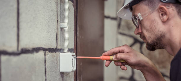 istock male electrician-technician, connects the equipment with a tool 1013823430