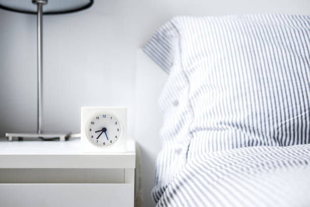 istock Alarm clock in white bedroom iterior 1013835074
