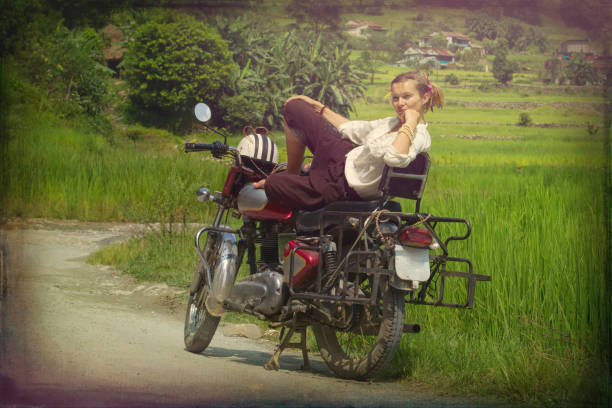istock young woman relaxes sunbathing on a red motorcycle 1013839954