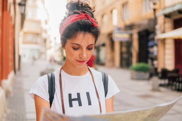 istock Woman looking at touristic map 1013847094