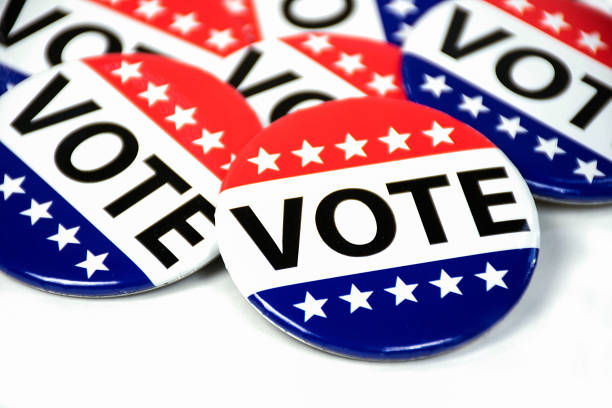 close up of campaign voting flag pins on white stock photo